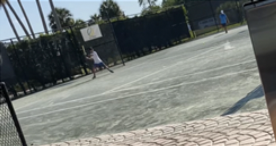 Sejong Kim, a 7th grader at OHS and a competitive tennis player, practices on the court.