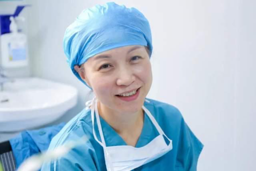 Dr. Lichun Han prepares for surgery following a morning consultation.