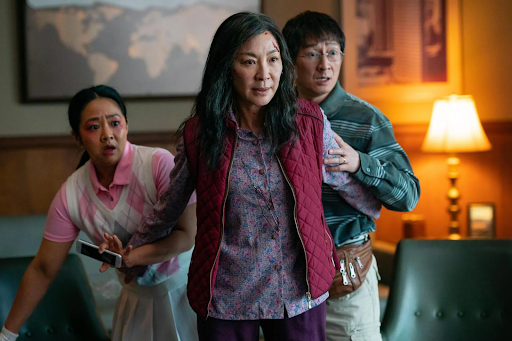 Stephanie Hsu, Michelle Yeoh, and Ke Huy Quan as Joy Wang, Evelyn Quan Wang, and Waymond Wang in the interdimensional sci-fi film, Everything Everywhere All at Once (2022). 