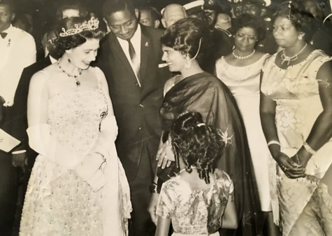 Queen Elizabeth II greets Guyanese citizens alongside Prime Minister, Forbes Burnham. National composer, Valerie Rodway, stands far right.