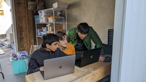 Ryan Lin (right) helping the software team through a coding conundrum in his backyard at a chilly Saturday onsite meeting. 