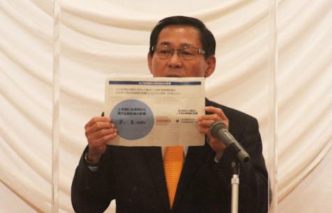 Toshifumi Kojima, Liberal Democratic Party Member of the House of Representatives, explains a poster on levels of radiation in the purified wastewater from the Fukushima Daiichi nuclear plant.