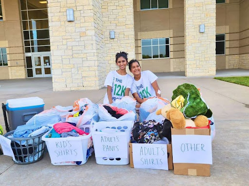 Neha Gadde (left) and Hridha Mathuria (right) posing with boxes filled to the brim with clothes that had been donated to 12k. (Source: Gadde and Mathuria)