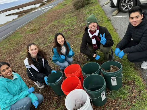 Members of the park clean-up team (L-R) Aanya Gupta ('27), Ryann Harris (‘28), Ellie Shen (‘27), Davis Yeh ('26) and Connor Yeh (‘25), with their seven buckets of trash. (Photo source: Eva Lu)
