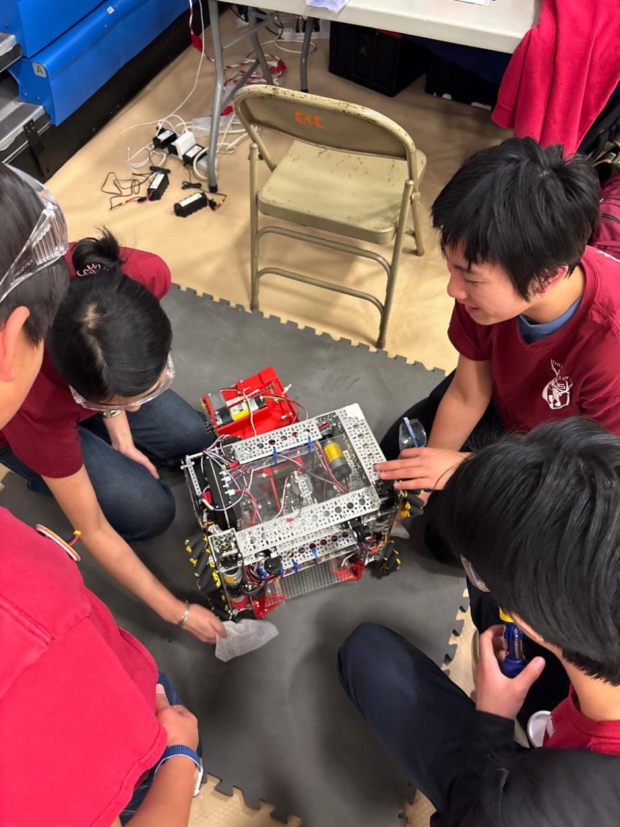 OHS’s FTC Team 5206, The Knights of Ni, rubbing down the robot with a dryer sheet during the pit stop between two matches at the Folsom Qualifying Tournament #1. 