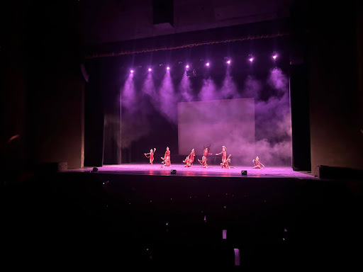The dancers hold their final pose in the moment before the curtain drags across the stage, bringing the performance to an end.